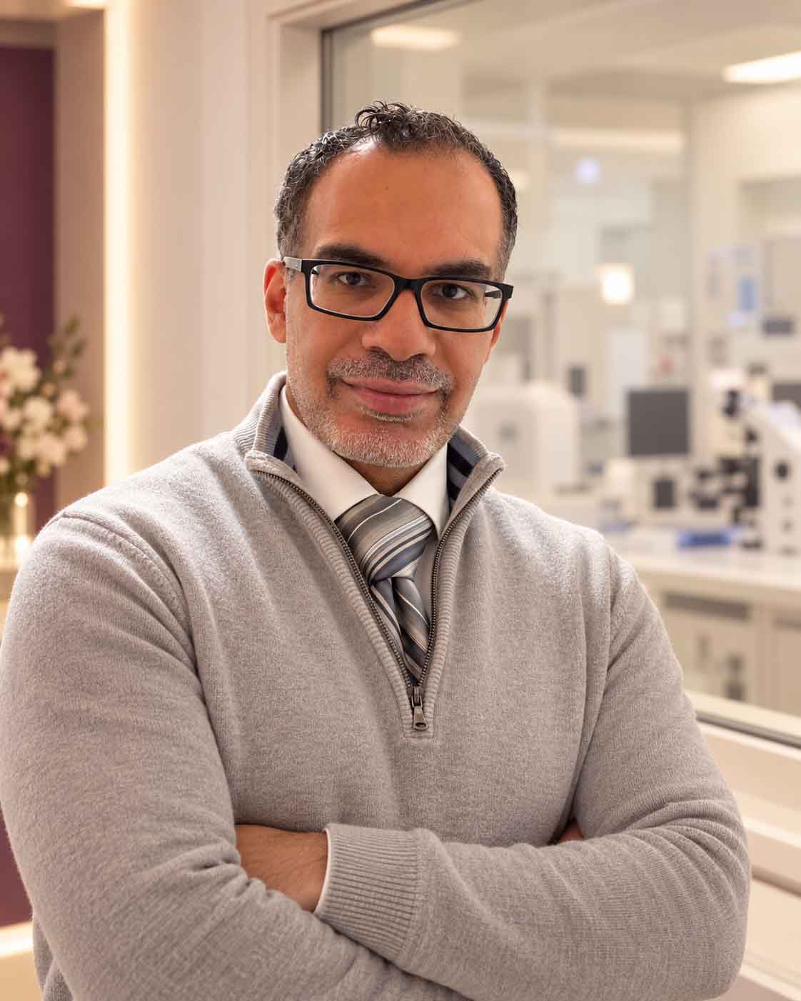 Dr Elsheikh beside an IVF laboratory window